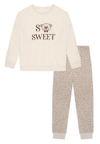 Beige sweatshirt with "SO SWEET" text and a bear graphic; paired with beige leopard print sweatpants; both in soft cotton material.