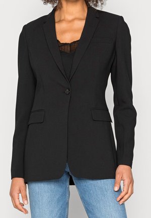 Blazer noir avec une fermeture à un bouton, coupe slim, revers crantés et deux poches avant. Fabriqué à partir d'un tissu lisse et texturé.