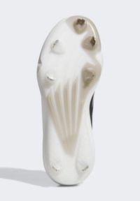 White athletic shoe sole with molded traction studs, textured surface pattern, and a curved design. Features slight color gradient from white to beige.