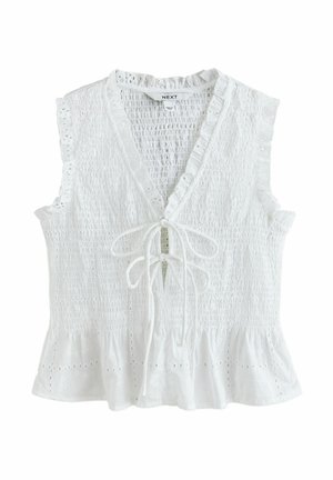 Bluza albă fără mâneci, cu corp strâns prin smocuri, detalii cu găuri decorative, margini cu volănașe, decolteu în formă de V și închidere cu nod în față.