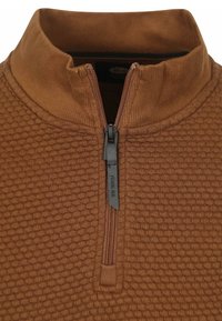 Zip-neck pullover in warm bruin, met een textuurpatroon, geribbelde kraag en een korte rits met een zwarte trekstrip aan de voorkant.