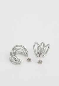 Silver hoop earrings featuring a twisted design, made of metal, with a shiny, reflective surface and a post-back closure.
