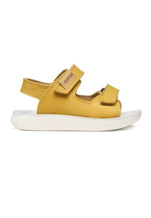 Sandalo giallo per bambini con due cinturini in velcro regolabili e suola bianca imbottita, vista laterale.