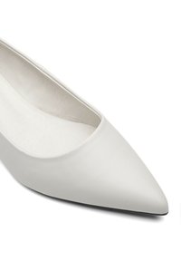 White leather pump with a pointed toe, smooth texture, and a minimalistic design. Interior shows soft lining, lacking any visible hardware.