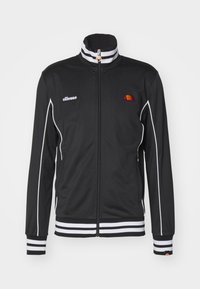 Sort hættejakke med lynlås lavet af glat stof, med hvide striber på kraven og ærmekanterne, samt et broderet logo på venstre bryst.