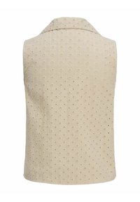 Ärmlös beige väst med krage, med en strukturerad tyg med broderade blommönster och perforerade detaljer.