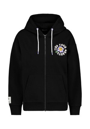 Schwarze Kapuzenjacke mit einem Frontaufdruck, der "FIND YOUR GROOVE" und ein lächelndes Blumenmotiv zeigt. Verfügt über Kordeln und Fronttaschen.