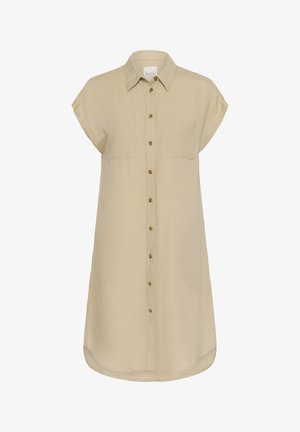 Beige mekko napilla, jossa on hihaton malli, kaksi etutaskua ja kaareva helma. Valmistettu kevyestä kankaasta, jossa on pehmeä rakenne.