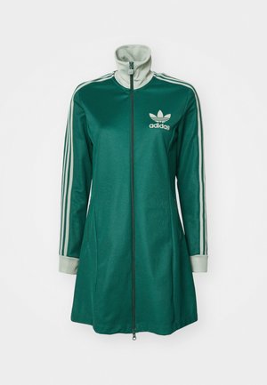 Veste de sport zippée verte avec un col haut, trois bandes blanches sur les manches, des poignets crème et le logo Adidas sur la poitrine.