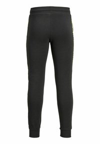 Sorte sweatpants lavet af blødt stof, med en tætsiddende design, elastisk talje og ribbede manchetter. Sideakkenter i en lys farve.