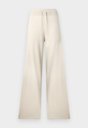 Beige weite Hosen aus strukturiertem Stoff, mit elastischem Bund und verstellbarem Kordelzug. Keine sichtbaren Taschen oder Muster.