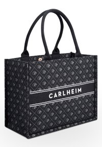 Black fabric tote bag with a patterned design featuring the logo. Two sturdy handles, rectangular shape, reinforced sides, and a solid base.