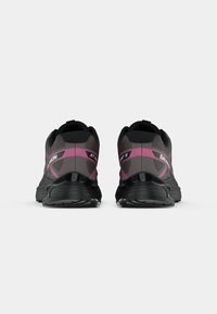 Black and gray running shoes with pink accents, featuring a textured upper, thick sole, and reinforced heel design for support.