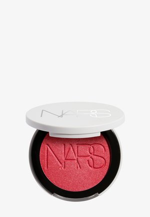 Compact de blush NARS rose-rouge scintillant avec couvercle blanc partiellement ouvert, montrant le nom de la marque embossé sur la surface du produit.