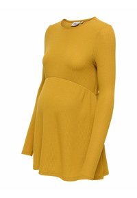 Senapsgul långärmad topp med ribbad textur, utsvängd form och en böjd söm under bysten för en figurnära utseende.