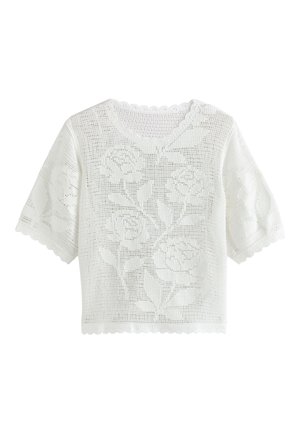 Haut blanc en crochet à manches courtes avec motifs floraux, bords festonnés aux manches, à l'encolure et à l'ourlet.