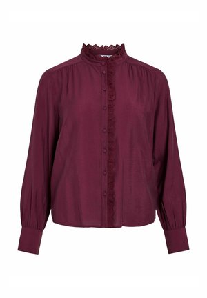 Bordeaux-bluse med lange ærmer, en flæsset blondekrave, frontlukning med knapper og subtil tekstur i hele stoffet.