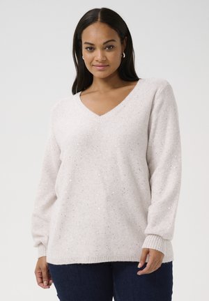 Light beige sweater in a soft knit with a V-neck, featuring scattered metallic specks, long sleeves, and ribbed cuffs.