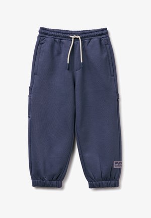 Marineblaue Jogginghose mit einem Kordelzug, elastischen Bündchen, Seitentaschen und einer Seitentasche mit einem Etikett. Hergestellt aus weichem Stoff.