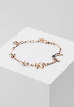 Delicada pulsera de cadena de oro rosa con dijes de estrella y luna creciente, algunas estrellas con detalles de piedras preciosas claras.