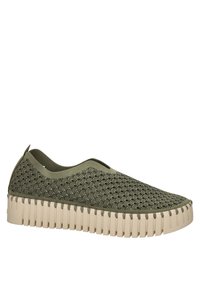 Zelená nazouvací bota s texturovaným svrškem s vlnkovými vzory a silnou, drsnou béžovou podrážkou. Bezešvý design s elastickými bočními vložkami.