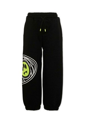 Pantaloni da jogging neri con vita e polsini elasticizzati, con una grande grafica verde e bianca di un volto sulla gamba sinistra.