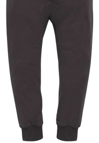 Schwarze Jogginghose aus weichem Stoff, mit einem taillierten Bein Design, gerippten Bündchen und einem runden Kniepatch.