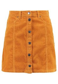 Jupe en velours côtelé orange vif, avec une silhouette ajustée, une fermeture à cinq boutons sur le devant et deux poches latérales. Tissu côtelé texturé.