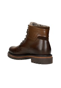 Stivaletto in pelle marrone con finitura testurizzata, lacci e morbido rivestimento in pelliccia sul bordo. Caratterizzato da una suola in gomma robusta con battistrada.