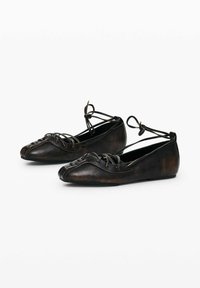 Dark leather ballet flats with a pointed toe, lace detailing across the upper, and ankle ties, featuring a smooth, polished texture.
