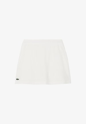 Falda blanca de algodón con un diseño acampanado, cintura elástica y un pequeño logo verde de Lacoste en el lado izquierdo. Textura suave.