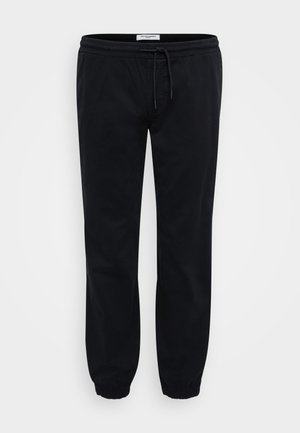 Black sweatpants made of soft cotton with an elastic waistband and drawstring. Features elastic cuffs and side pockets for utility.