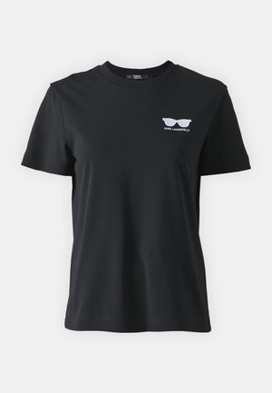 T-shirt en coton noir avec col rond, manches courtes et un petit logo de lunettes de soleil brodé en blanc sur la poitrine.