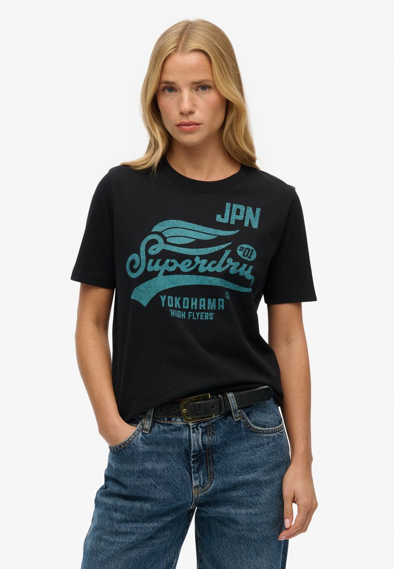 Sort bomulds T-shirt med turkise grafiske bogstaver og logo, rund halsudskæring, korte ærmer og afslappet pasform.