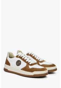 Białe i brązowe sneakersy z materiałów zamszowych i skórzanych, z perforowanym czubkiem, okrągłymi sznurówkami oraz okrągłym logo z boku.