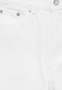 White denim jeans with a smooth texture, featuring silver hardware accents, a front pocket, and a classic waistband design.