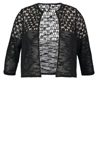Cardigan noir tricoté ouvert sur le devant avec un motif crochet ample et aérien et des manches longues, présenté sur un fond blanc.