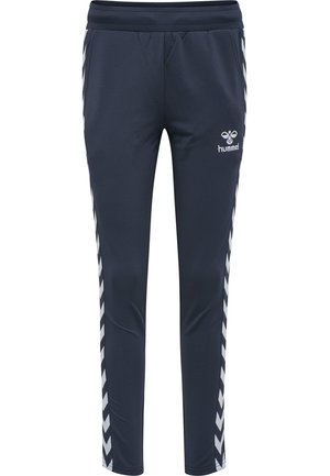 Pantalons de sport navy avec une coupe tapered, taille élastique et bandes en chevron blanches contrastantes sur les côtés. Logo Hummel à l'avant.