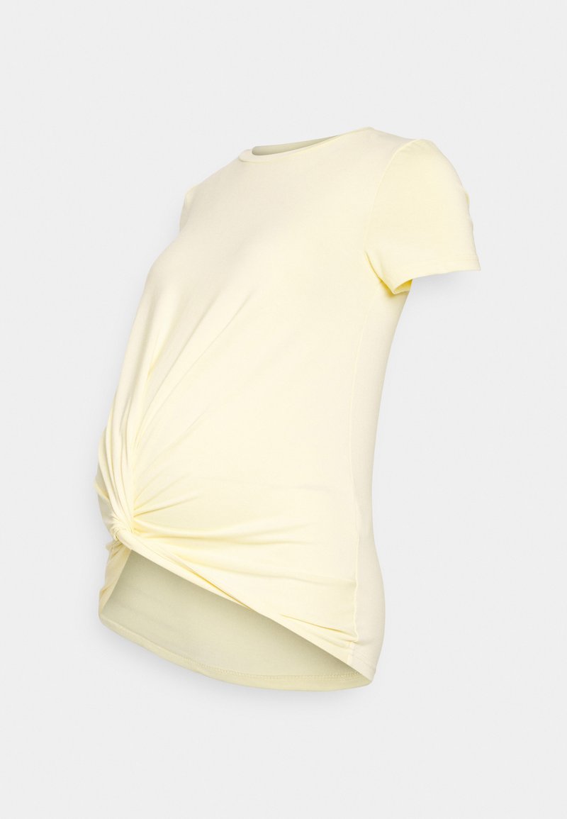 Camisola de maternidade amarela clara com gola redonda, mangas curtas e detalhes franzidos de lado para um ajuste justo. Tecido macio e elástico.