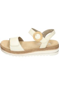 Witte leren sandaal met een geweven cirkelaccent, verstelbare band, zachte beige binnenzool en een textuur, duurzame zool met een lichte plateauhoogte.