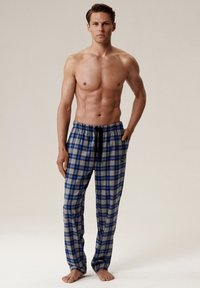 Niebieskie i szare spodnie piżamowe w kratę z elastycznym pasem i bocznymi kieszeniami. Wykonane z lekkiego materiału, z logo na lewej udzie.