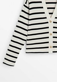Black and white striped cardigan made of ribbed fabric, featuring a deep V-neck, gold-tone buttons, and long sleeves with a cropped design.