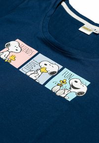 Navy blue cotton t-shirt featuring Snoopy and Woodstock graphics with the words “Friends,” “Cuddle,” and “Fun” in contrasting panels. Round neckline.