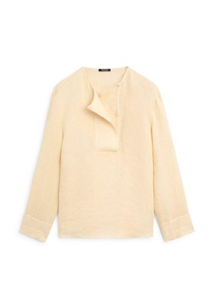 Beige hørskjorte med lange ærmer, asymmetrisk knappelukning og brede manchetter, lagt fladt på hvid baggrund.