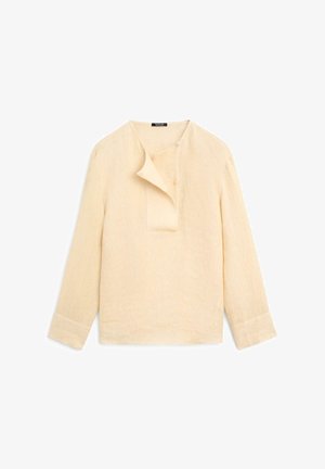 Beiges Leinenhemd mit langen Ärmeln, asymmetrischer Knopfleiste und breiten Manschetten, flach auf weißem Hintergrund präsentiert.