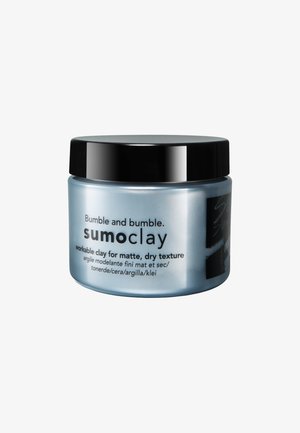 Bumble and Bumble Sumo Clay krukke, rund form, mat lyseblå beholder med sort låg, mærket til mat og tør teksturstylingler.