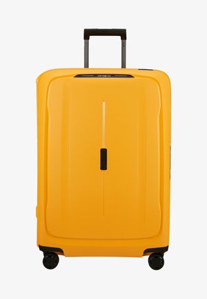 Yellow hard-shell suitcase with a retractable black handle, four wheels, and a smooth texture. Features a slim vertical design and minimal accents.