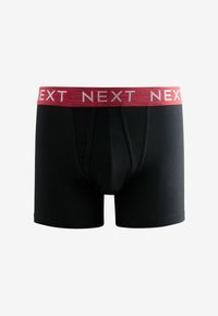 Fekete pamut boxer short, piros csíkos derékkal, amelyen fehér színnel a "NEXT" felirat ismétlődik. Közép hosszúságú dizájn, snug (szoros) fazonnal.