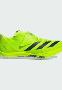 Bright neon green running shoes with black stripes. Features a lightweight mesh upper, adjustable strap, and spiked sole for traction.