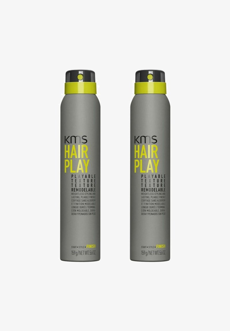 Gray aerosol canisters with black and bright yellow accents, labeled "KMS Hair Play." Text highlights re modelable, weightless styling.